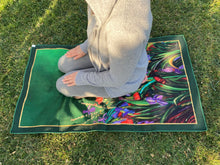 Load image into Gallery viewer, Artists self expression canvas inspired to convey the soul connection of mind body and soul. Empowering artists and artisans. Hand painted hints of gold scattered throughout the serenity mat. The artisanal redefinition of prayer and meditation mats. Life serenity mat by Fairuz Hamad. Nature flowers colors a garden of connection and consciousness. Woman in prayer in islam outdoor garden scene
